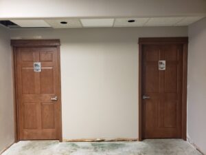 View of men's and woman's renovated bathroom doors